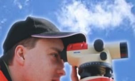 Individual using an auto level