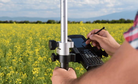 Land surveying with a GNSS receiver and data collector.