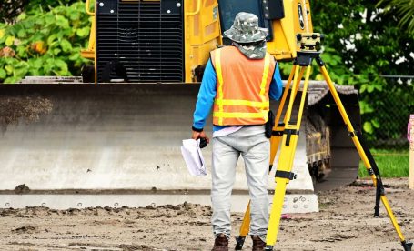 man on construction site using a total station